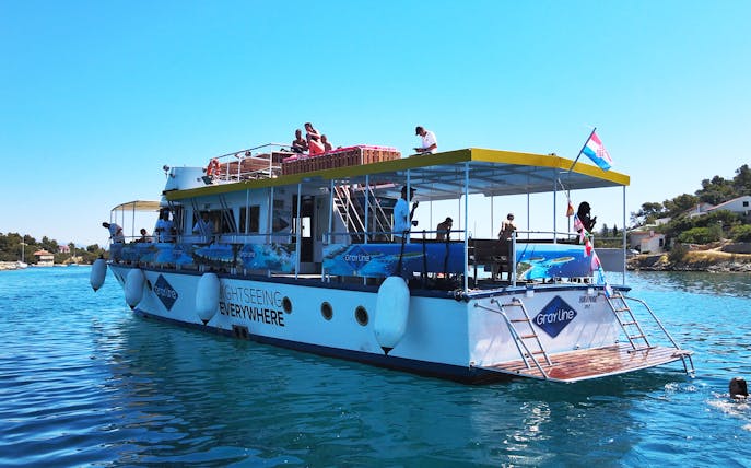 Sightseeing boat on Split Riviera with passengers enjoying a sunset cruise.