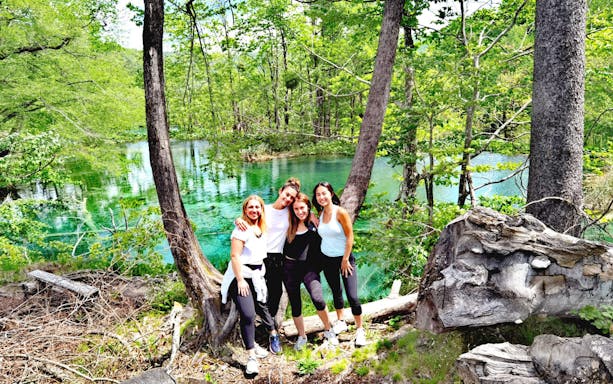 Group enjoying nature on a Split guided walking tour near a scenic lake.