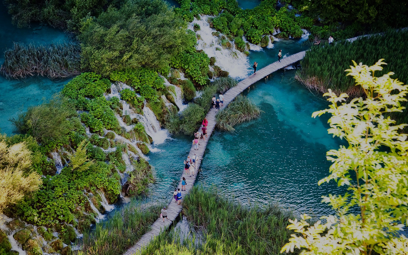 Tourists on special tracks around the lake at Plitvice Lakes National Park