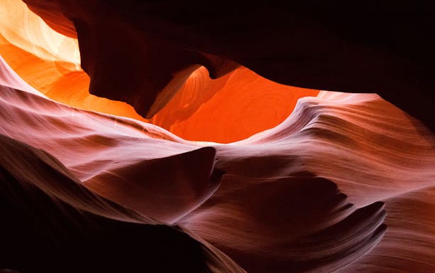 Antelope Canyon's smooth sandstone formations illuminated by sunlight.