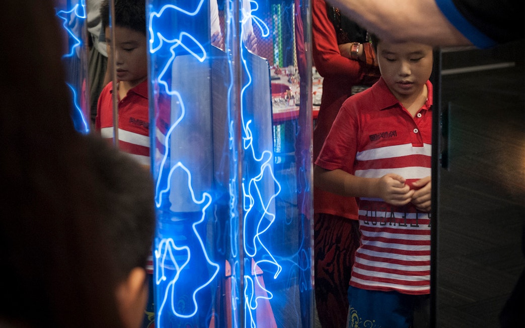 Child observing interactive exhibit at Tech Dome Penang.