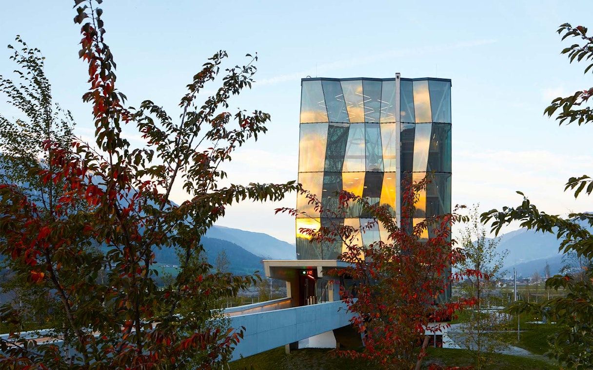 Swarovski Crystal Worlds entrance with modern glass architecture and surrounding trees.