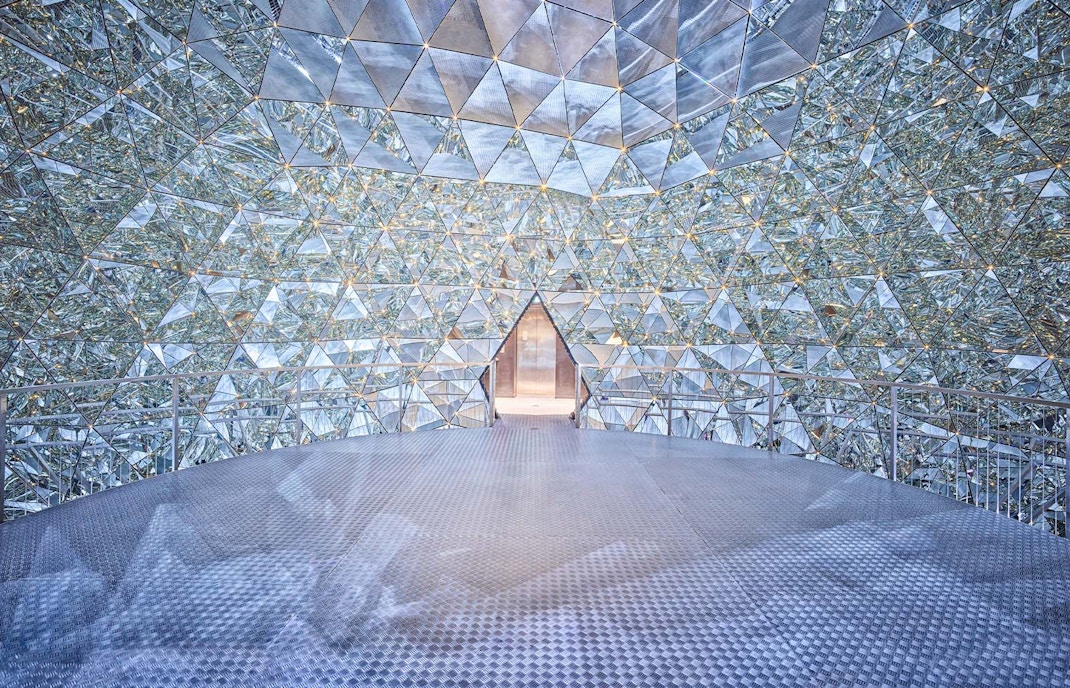 Swarovski Crystal Worlds entrance with visitors in Innsbruck, Austria.