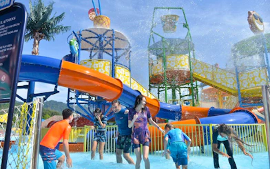 Visitors enjoying water slides at Langkawi Wildlife Park's Splash Out attraction.