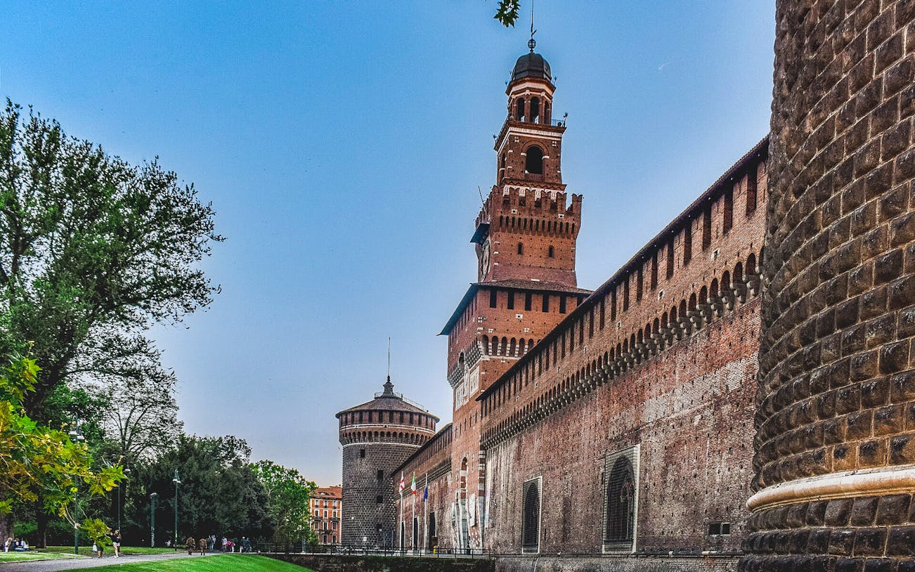 Sforza Castle exterior with tower and brick walls, Milan, Italy.