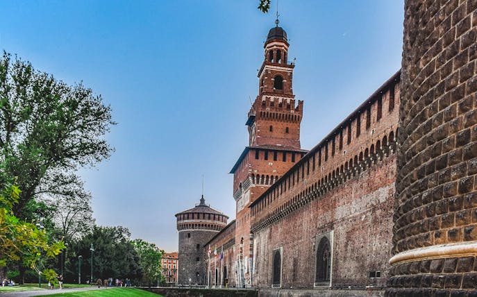 Sforza Castle exterior with tower and brick walls, Milan, Italy.