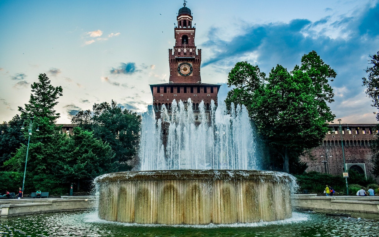 Sforza Castle entrance with fountain in Milan, Italy, during a self-guided tour.