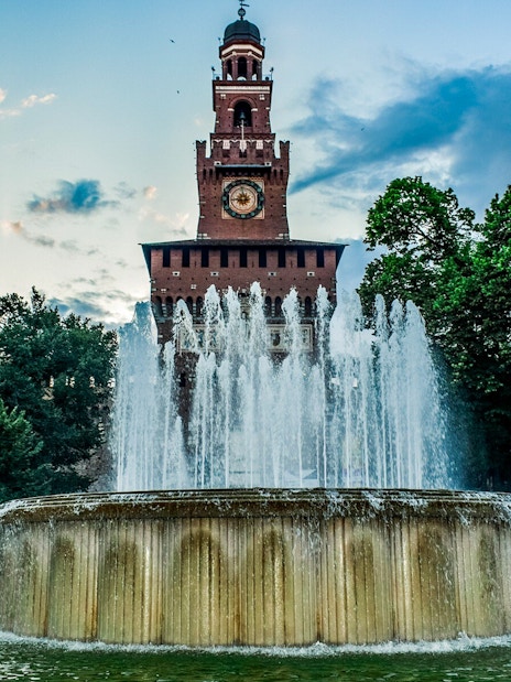 Sforza Castle entrance with fountain in Milan, Italy, during a self-guided tour.