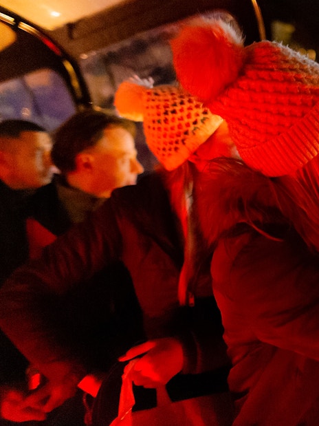 Guests enjoying an Amsterdam evening canal cruise, capturing city lights.