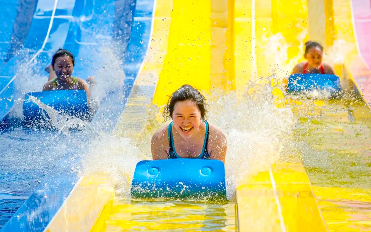 Visitors enjoying water slides at ESCAPE Penang.