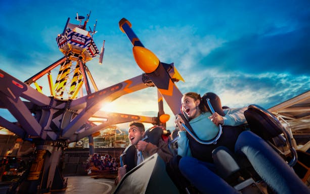 Visitors enjoying a thrilling ride at Skytropolis Theme Park.