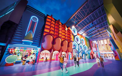 Visitors exploring vibrant neon-lit attractions at Genting SkyWorld Outdoor Theme Park.