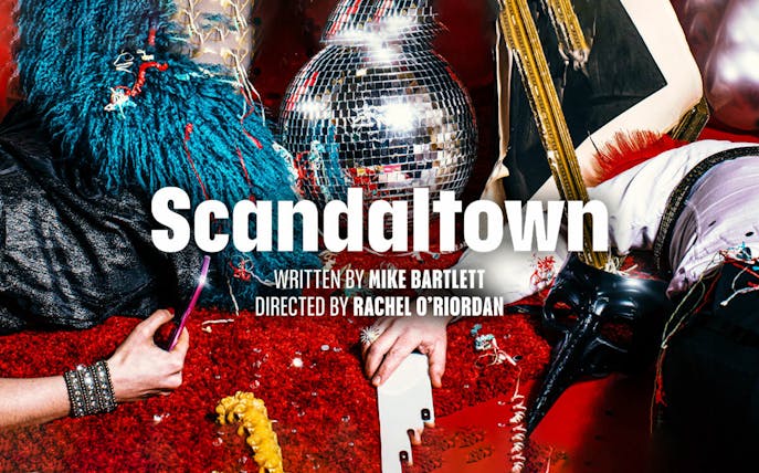 Scandaltown play poster with disco ball and colorful costumes.