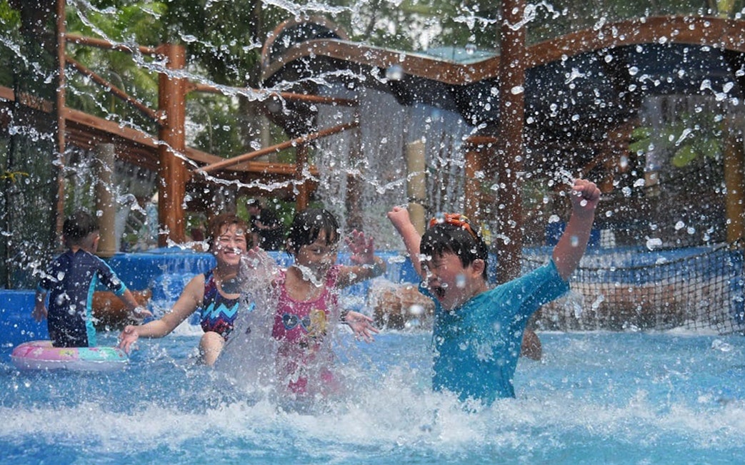 Children playing in a splash zone at Wet World Water Park Shah Alam.