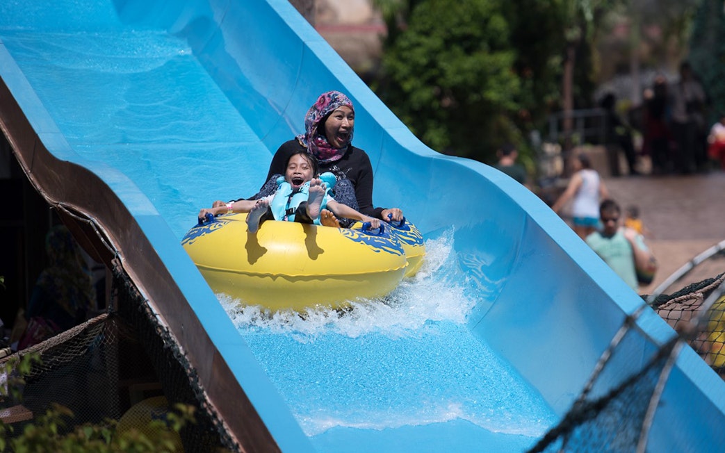 Family enjoying a water slide at Wet World Water Park Shah Alam.