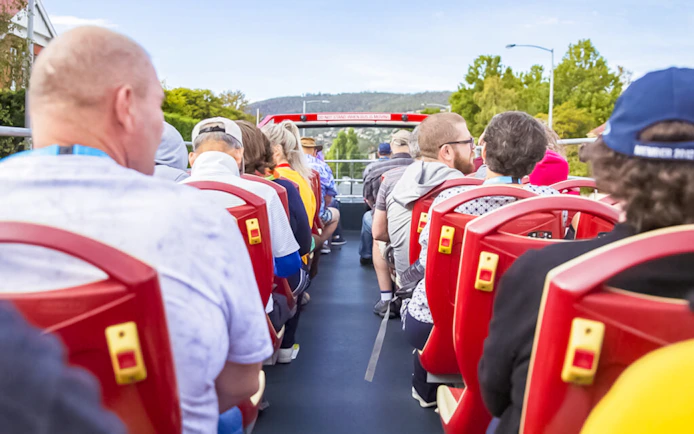 Passengers seated on an open-top bus during the Hobart Hop-On Hop-Off Sightseeing Tour.