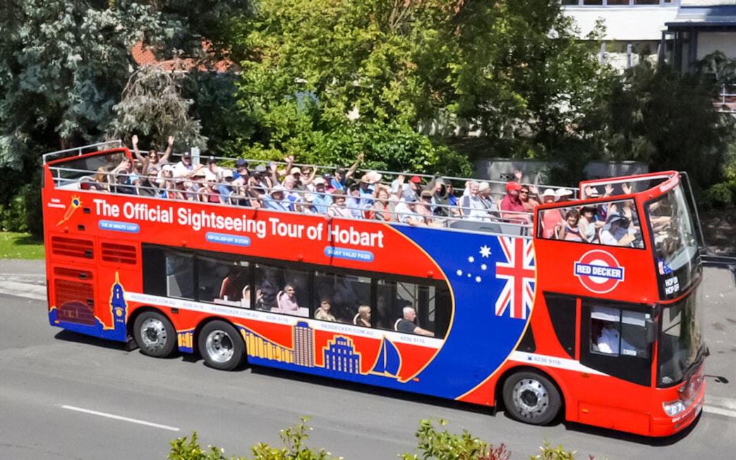 Hobart sightseeing bus with passengers on an open-top deck.