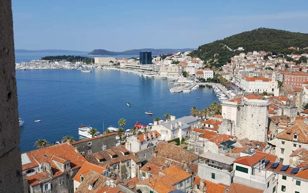 Split cityscape with harbor view, featuring historic buildings and coastline, Croatia.