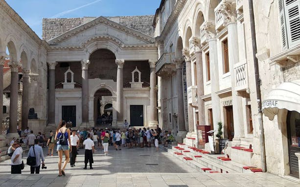 Crowd exploring Diocletian's Palace courtyard on Split walking tour.