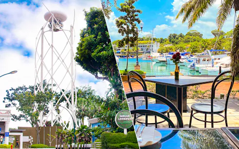SkyHelix Sentosa tower and waterfront dining area with yachts in Sentosa, Singapore.