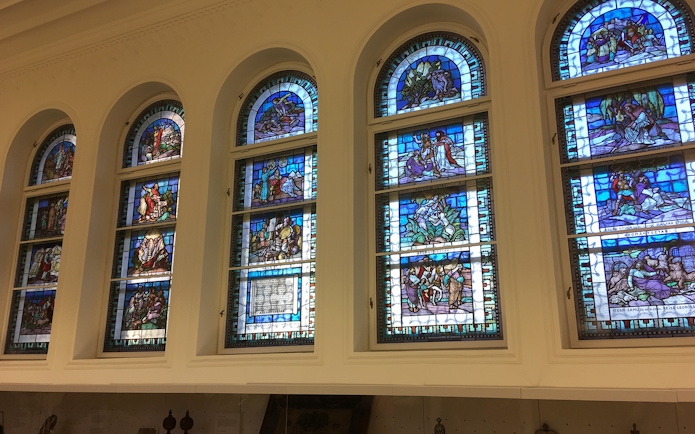 Stained glass windows inside Dohany Street Synagogue, Budapest, depicting biblical scenes.