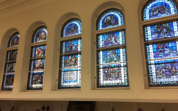 Stained glass windows inside Dohany Street Synagogue, Budapest, depicting biblical scenes.