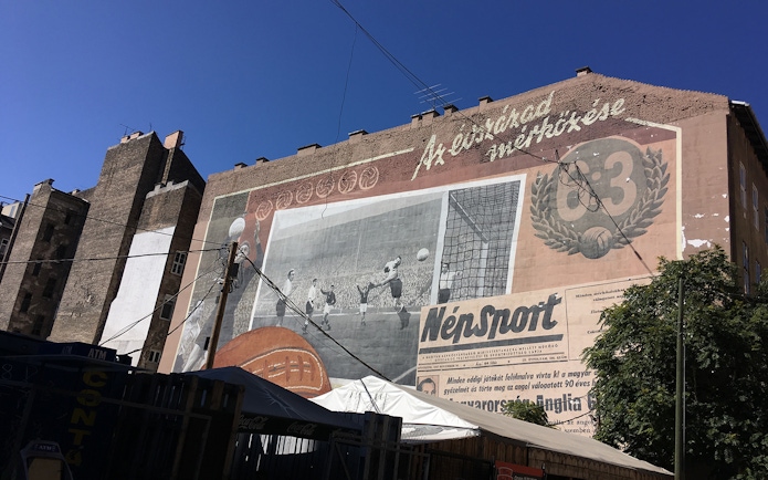 Mural on a building in Budapest depicting a historic soccer match, part of the Jewish Heritage Tour.