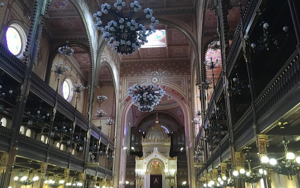 Interior of Dohany Street Synagogue with ornate arches and chandeliers, Budapest.