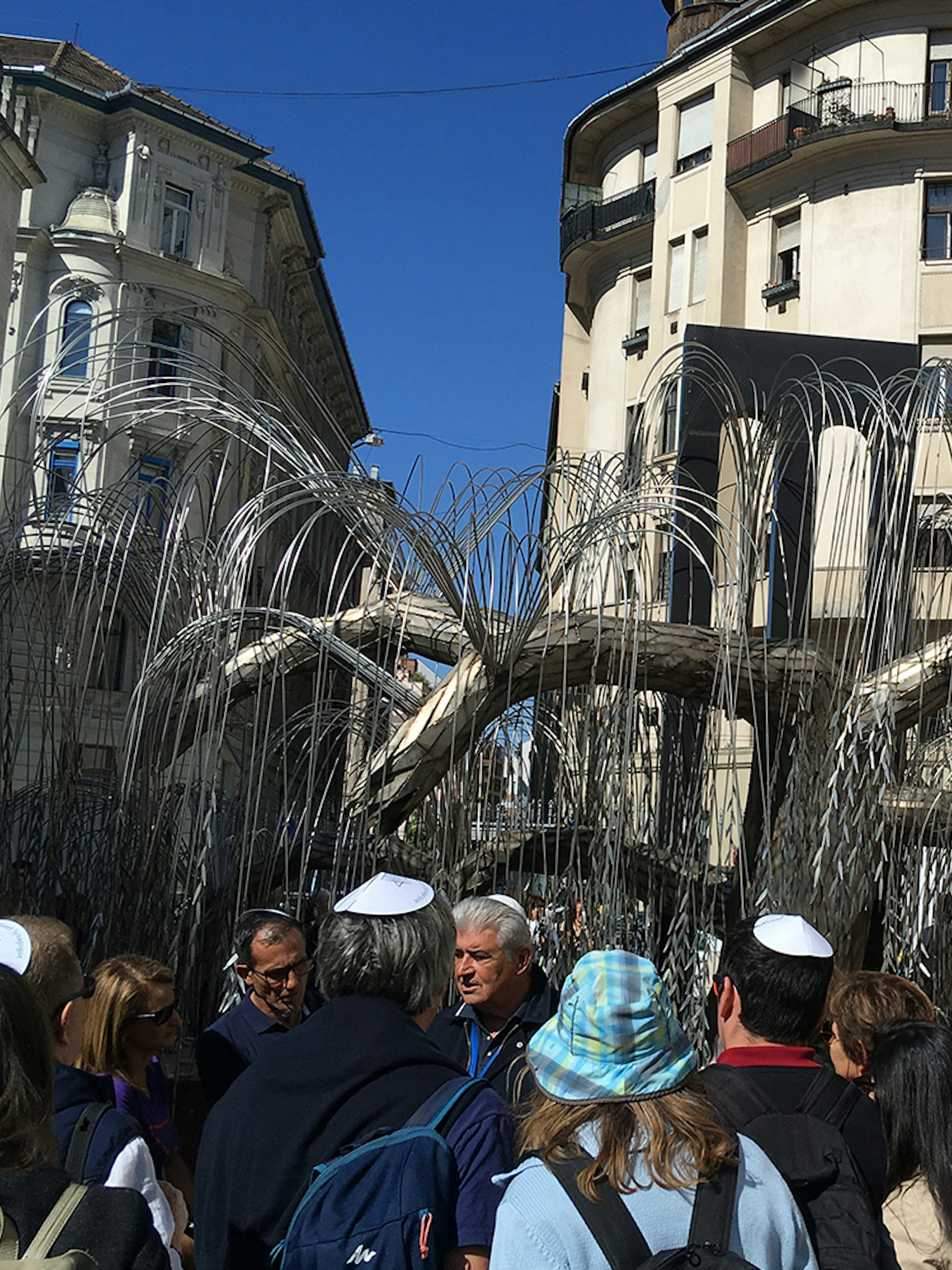 Group of tourists at the Tree of Life memorial, Dohany Street Synagogue, Budapest.