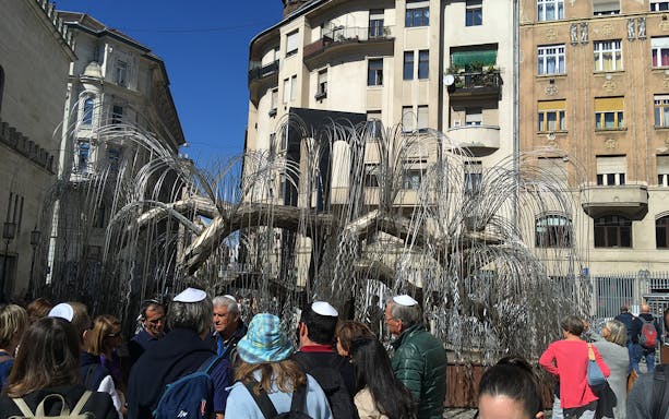 Group of tourists at the Tree of Life memorial, Dohany Street Synagogue, Budapest.