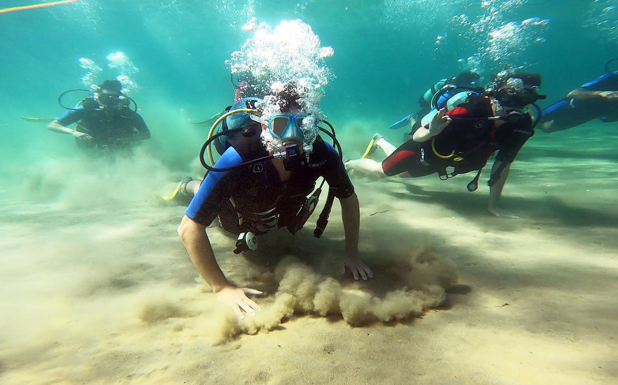 Scuba divers exploring underwater in Nea Makri, Athens.