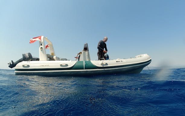 Certified diver preparing for adventure dive from boat in Nea Makri, Athens.