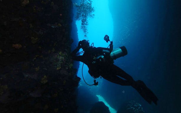 Diver exploring underwater cave in Nea Makri, Athens.