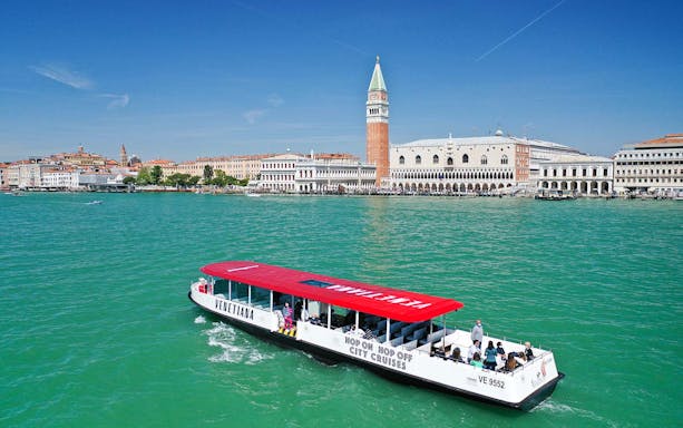 Hop-on hop-off boat near St. Mark's Campanile, Venice.