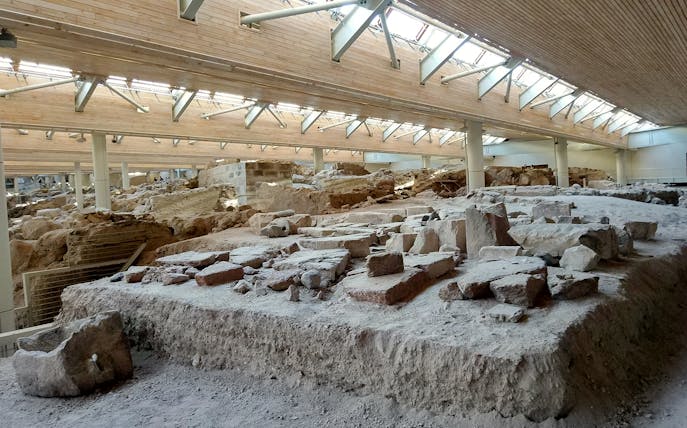 Akrotiri ruins under protective structure on guided tour in Santorini, Greece.
