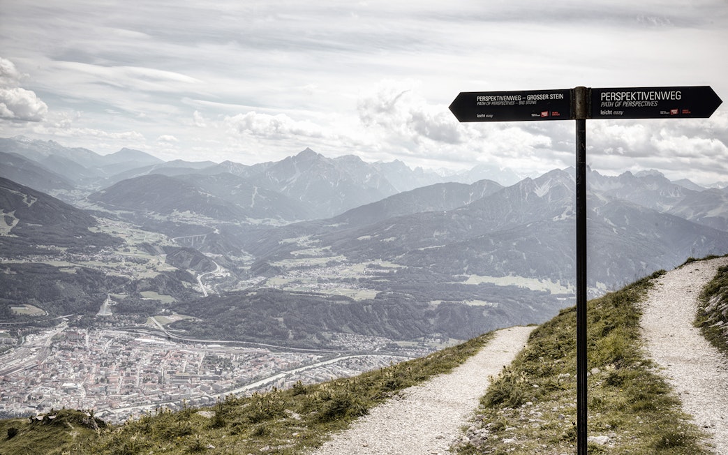 Path of Perspectives sign overlooking Innsbruck valley and mountains, Austria.