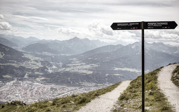 Path of Perspectives sign overlooking Innsbruck valley and mountains, Austria.