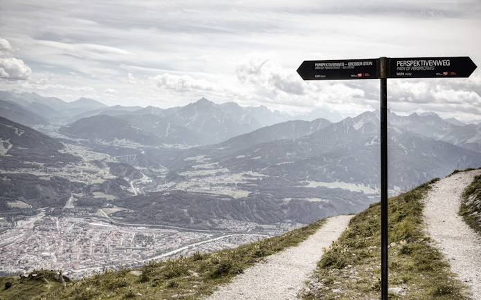 Path of Perspectives sign overlooking Innsbruck valley and mountains, Austria.