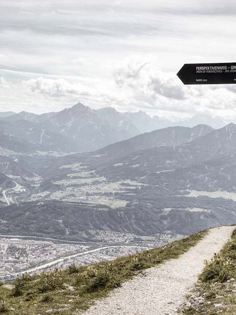 Path of Perspectives sign overlooking Innsbruck valley and mountains, Austria.