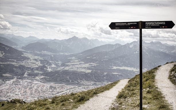Path of Perspectives sign overlooking Innsbruck valley and mountains, Austria.