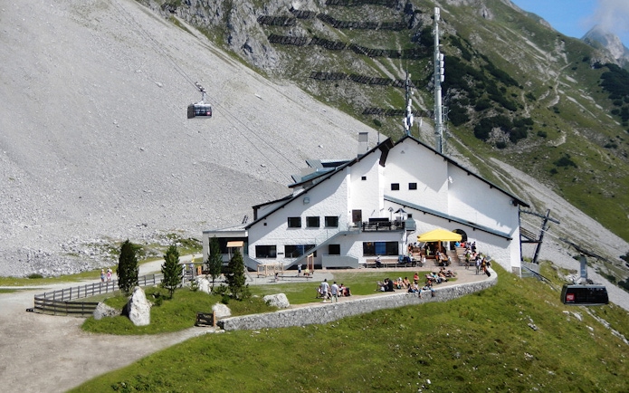 Cable car arriving at mountain station with visitors on terrace, Top of Innsbruck PLUS.