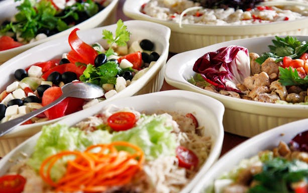 Hungarian dishes with fresh vegetables and herbs served on a Danube dinner cruise.