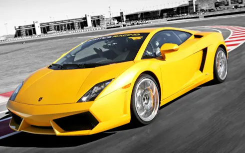 Yellow Lamborghini on a racetrack, showcasing the Drive a Supercar experience.