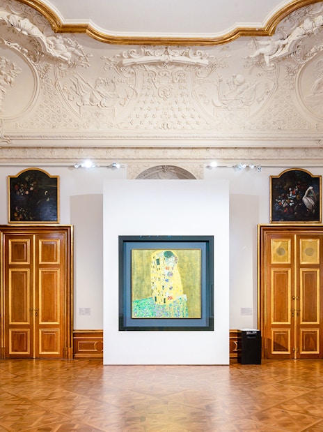 Interior of Belvedere Palace with Klimt's "The Kiss" painting displayed.