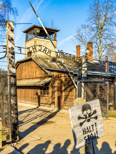Auschwitz-Birkenau entrance gate with warning sign, part of guided tour from Krakow.