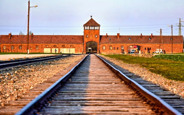 Rail tracks leading to Auschwitz-Birkenau entrance, part of guided tour from Krakow.