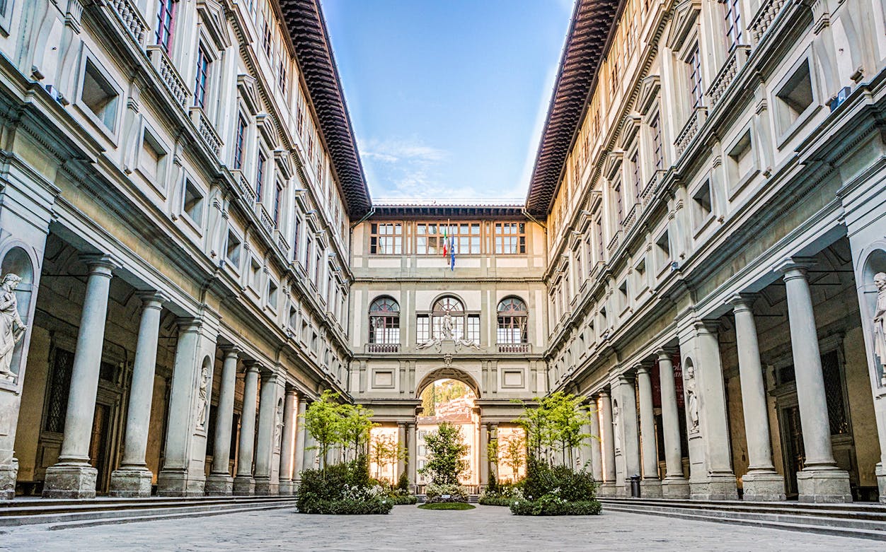 Uffizi Gallery courtyard with statues and columns, Florence, Italy.