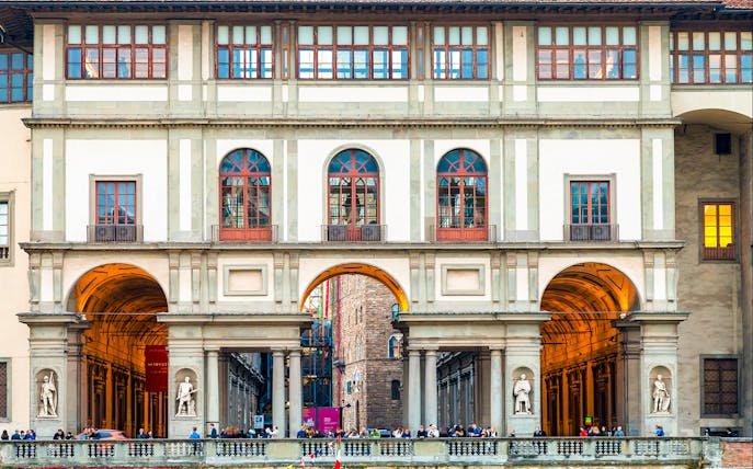 Uffizi Gallery exterior with statues and arches, Florence, Italy.