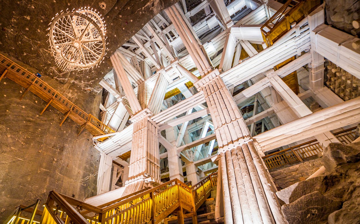 Wieliczka Salt Mine interior with wooden structures and chandelier.
