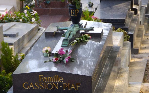 Grave of Famille Gassion-Piaf with flowers at Père Lachaise Cemetery, Paris.